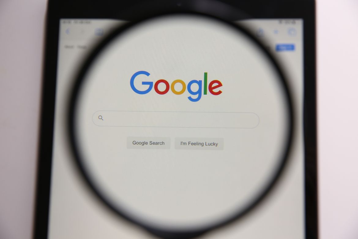 magnifying glass with Google in the middle