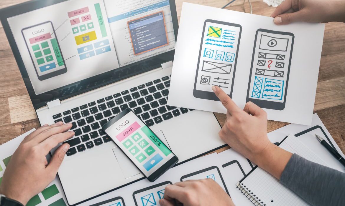 laptop and paper web design layouts