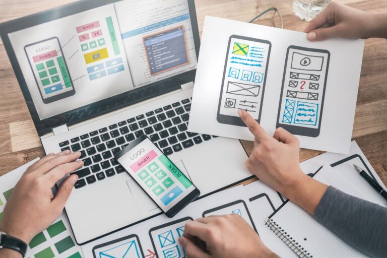 laptop and paper web design layouts