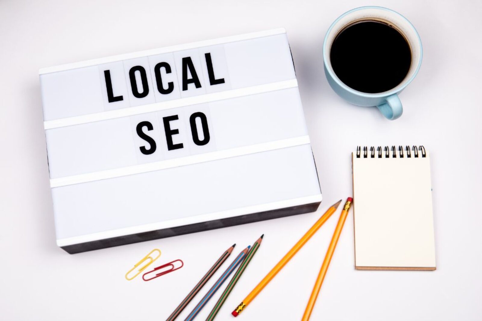 cup of coffee, note pad and text that reads "local SEO"