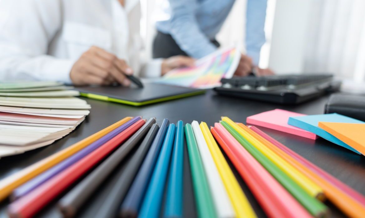 colored pencils on a table with web designers planning color themes