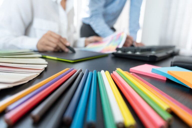 colored pencils on a table with web designers planning color themes