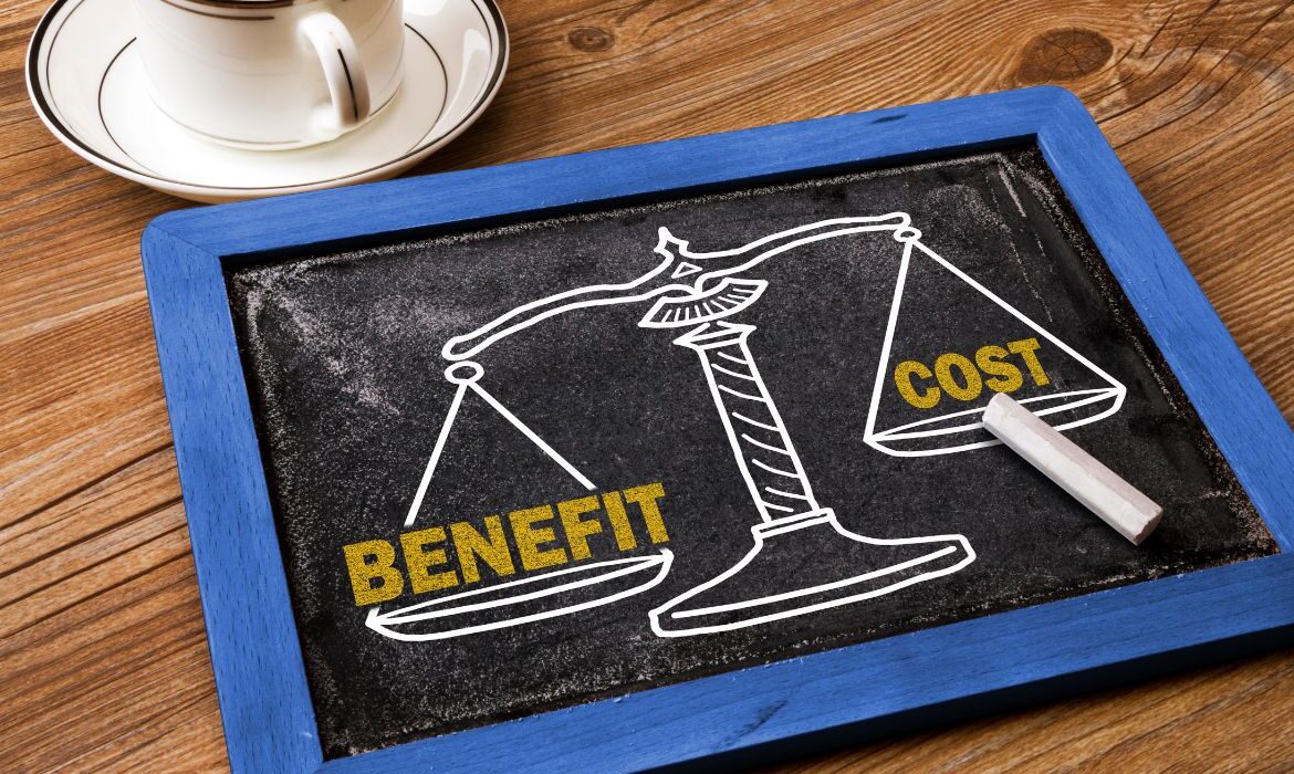 chalk board with scale measuring benefit vs cost