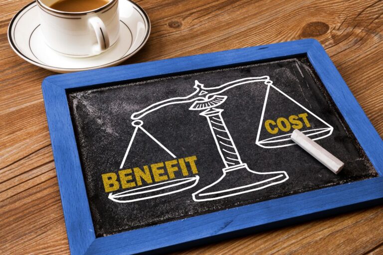 chalk board with scale measuring benefit vs cost