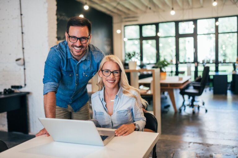small business owners looking at laptop