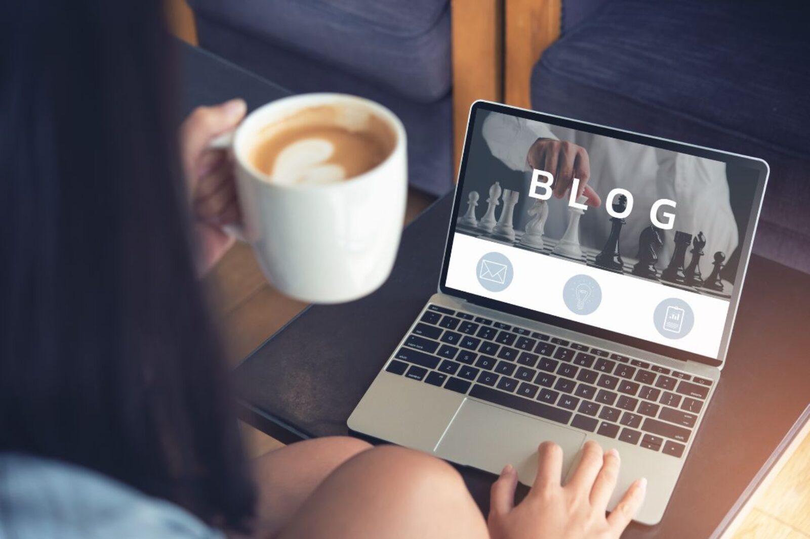 open laptop with the word "blog" on the screen and a cup of coffee