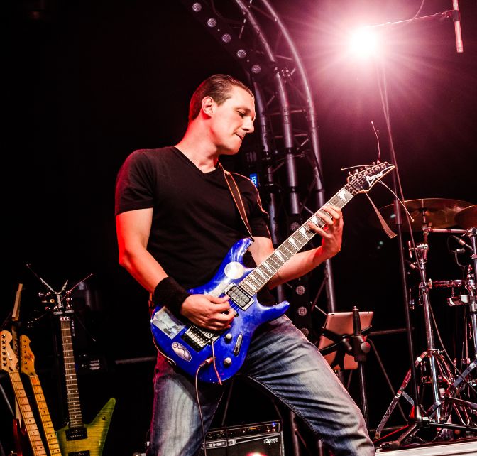 man playing guitar on stage