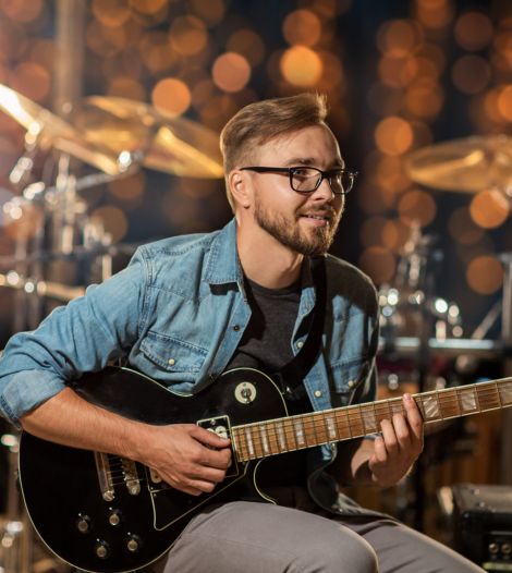 Musician webistes man playing guitar